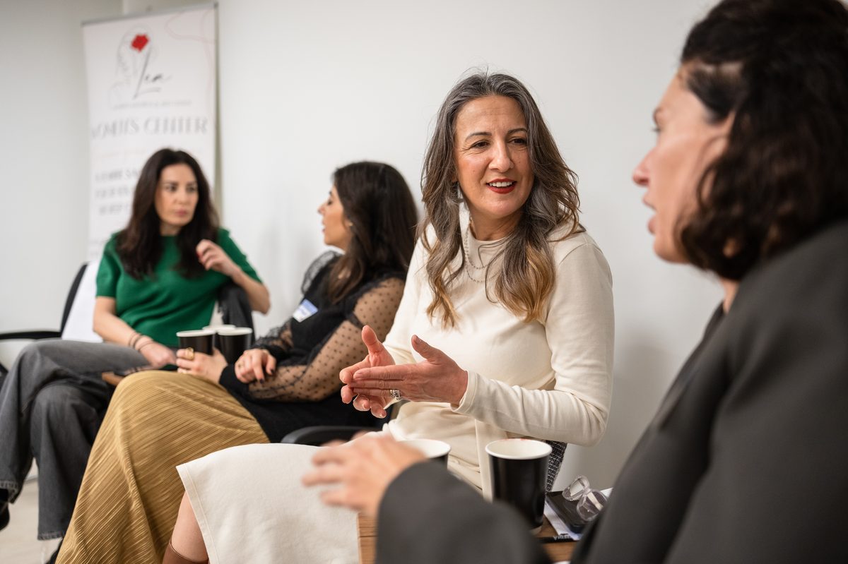 Two women in candid conversation at the launch event